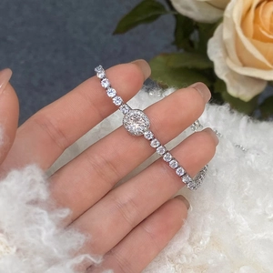 Close-up of a delicate zircon tennis bracelet with adjustable chain on a woman's wrist