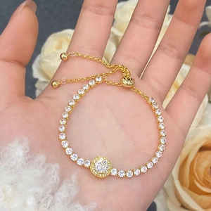 Detail of adjustable gold tennis bracelet with shimmering round cubic zirconia stones