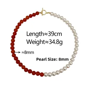 Detail of red agate and white pearl necklace featuring a gold OT clasp closure