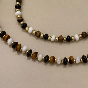 Elegant beaded necklace with tiger eye stone and white shell beads in minimalist design