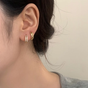 Gold-plated double-hoop earrings featuring one polished band and one pavé zircon band