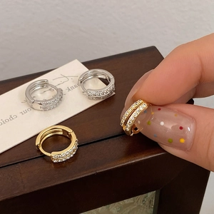 Detail of small gold hoop earrings with double-row micro-pave cubic zirconia stones