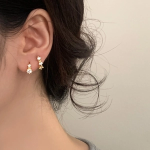 Elegant gold-plated hoop earrings with sparkling cubic zirconia on female model