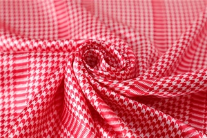Close-up of soft red and white houndstooth silk scarf showing premium fabric texture