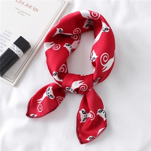 Detailed view of red cat print silk scarf with paisley pattern and elegant knot styling
