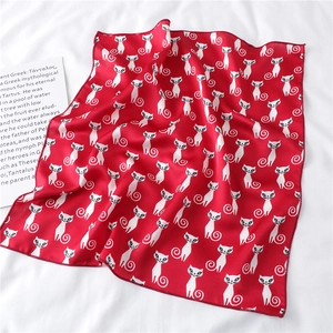 Detail of red square silk scarf with white cat prints and fine edge stitching