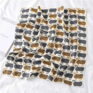 Close-up of sheep pattern scarf with fine edge stitching on white fabric background