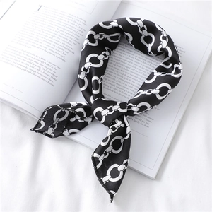 Detail of silk scarf with black and white chain-link print on vintage book