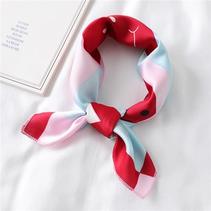 Close-up of a vibrant silk neckerchief with geometric color-blocking on white fabric