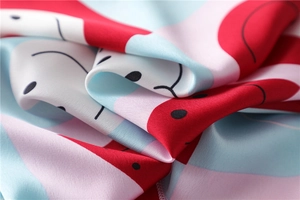 Macro detail of abstract geometric silk scarf fabric with smooth draped texture