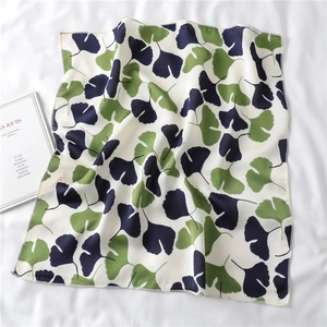 Detail of silk-like scarf with ginkgo leaf pattern and reinforced wave edge stitching