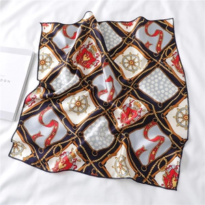 Detail view of square satin scarf featuring nautical chain and lion shield prints