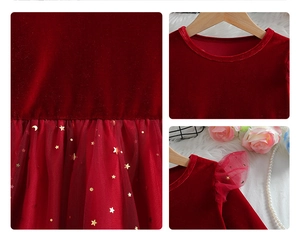Detailed close-up of girls' red velvet dress featuring golden star and moon mesh patterns