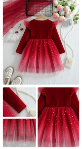 Detail of red velvet girls dress featuring gold star and moon sequins on mesh layers