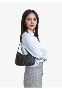 Sac sous l'aisselle en cuir verni noir brillant avec logo doré porté par mannequin