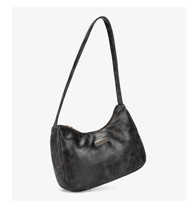 Détail de la texture vintage noire et de la barre métallique sur ce sac hobo élégant