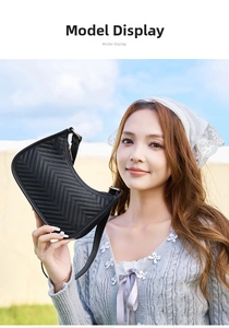 Close-up of black chevron quilted leather hobo bag with gold metal zipper and adjustable strap