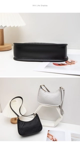 Detail view of V-shaped quilted half-moon shoulder bags in black and light grey colors