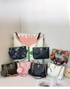 Detail view of quilted cylinder bag collection with gold chain strap and charm