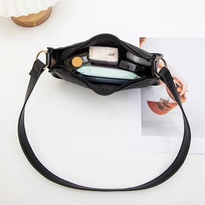 Chic black textured shoulder bag with spacious interior for essentials and gold metal hardware