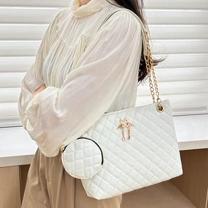 White quilted barrel crossbody bag with gold flamingo hardware and chain strap