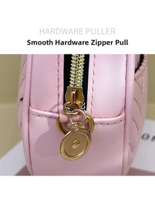 Macro shot of smooth gold hardware puller and pink quilted leather on women crossbody bag