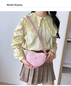 Model wearing a pink heart-shaped PU leather crossbody bag with chevron quilting