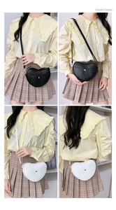Model display of heart-shaped quilted crossbody bags in black and white styles