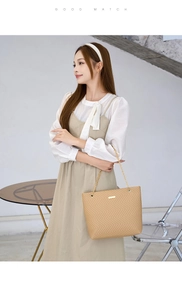 Detail of khaki quilted tote bag with gold chain strap and metallic logo plate