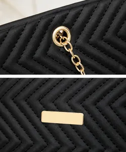 Detail view of black chevron quilted leather tote with gold hardware chain loops
