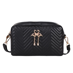Black quilted mini camera crossbody bag with gold swan heart logo and tassel detail