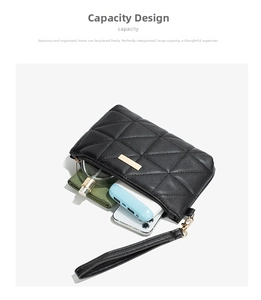 Detail view of black quilted mini clutch showing large capacity for phone and wallet