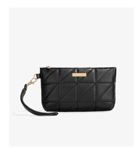 Close-up of black quilted pouch featuring premium leather texture and golden metal zipper