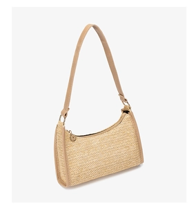 Close-up of beige woven texture and leather shoulder strap detail on a crossbody bag