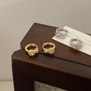 Elegant gold and silver hoop earrings with shimmering cubic zirconia in micro-prong setting