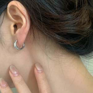 Minimalist silver hoop earrings with polished finish shown on model for daily wear