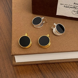 Detailed view of French vintage round stud earrings in gold and silver with black finish