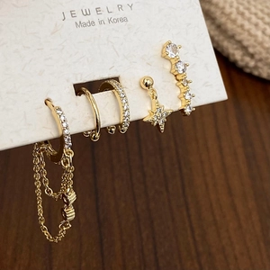 Detailed close-up of 5-piece gold moon and star earring set with zircon accents