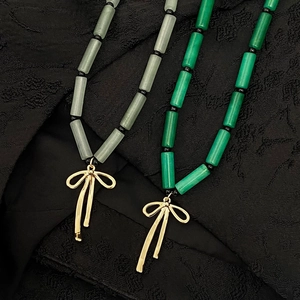 Bamboo style green stone necklace with golden bow pendant in retro Chinese aesthetic