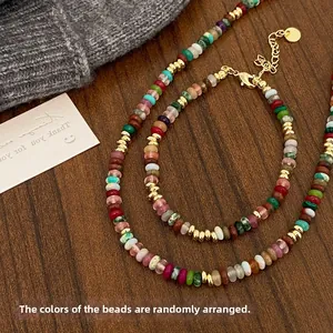 Detail of colorful stone beaded necklace set with gold spacers and lobster clasp detail
