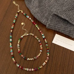 Detail of colorful bohemian natural stone beaded necklace set with gold spacers