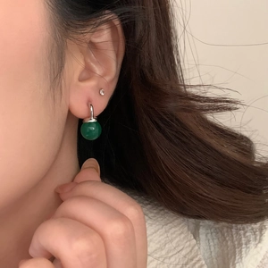 Elegant green chalcedony drop earrings with silver metal finish shown on model
