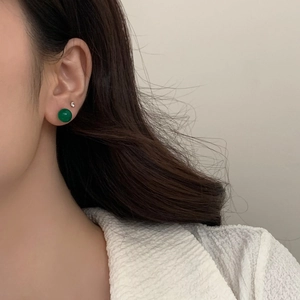 Close-up of elegant green chalcedony stud earring with a small sparkling diamond accent