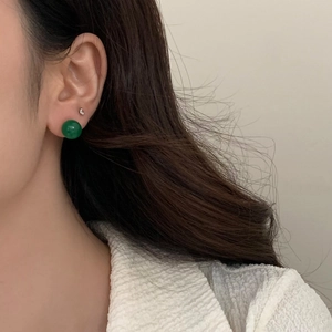 Elegant round green chalcedony stud earring in neo-Chinese style worn by a female model