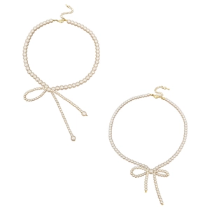 Elegant pearl choker necklace with gold bow pendant and adjustable lobster clasp