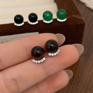 Detail view of round chalcedony stud earrings with sparkling micro zircon accents