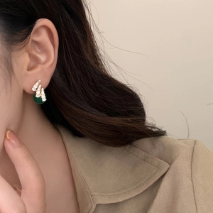 Vintage style emerald green drop earrings with sparkling zircon accents on gold metal