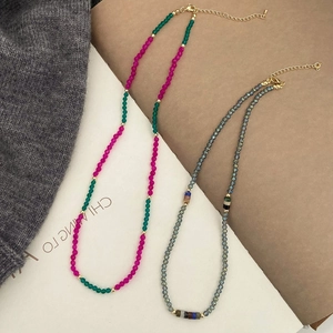 Close-up of handmade beaded necklaces with vibrant natural stones and golden lobster clasps