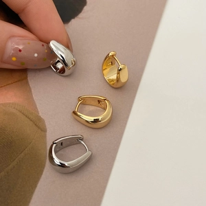 Minimalist U-shaped metal hoop earrings in polished gold and silver finish