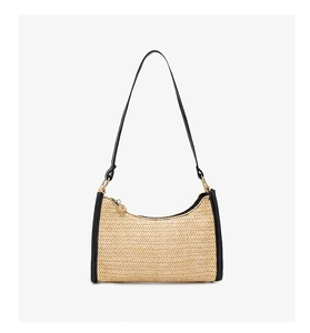Detail of woven straw texture and black leather strap with gold zipper on hobo bag